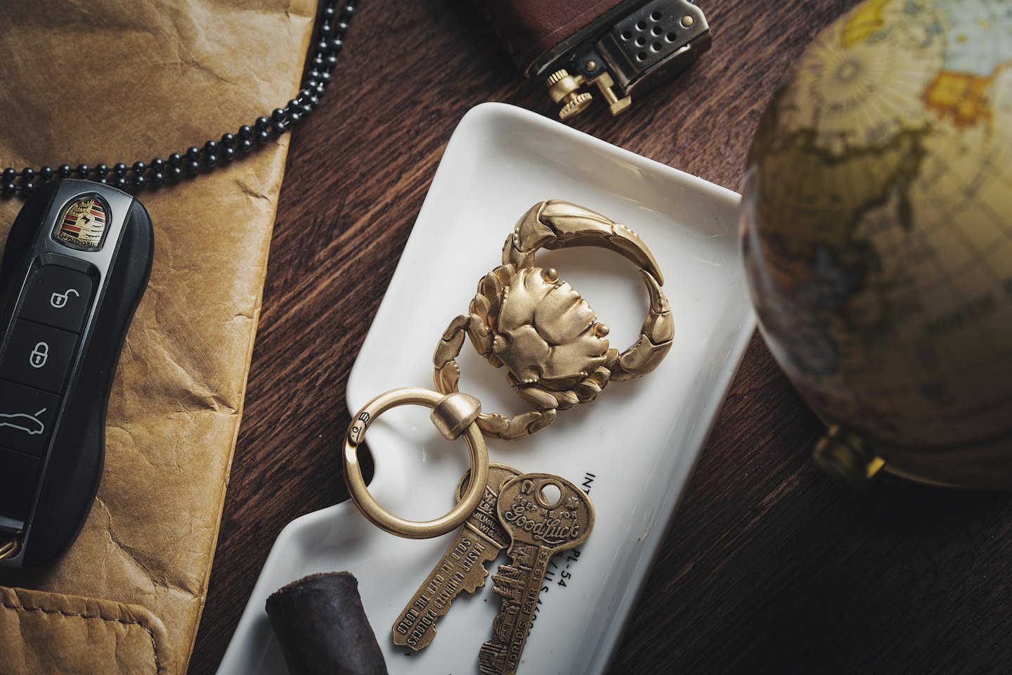 Assorted personal accessories arranged on a white tray and wooden table.